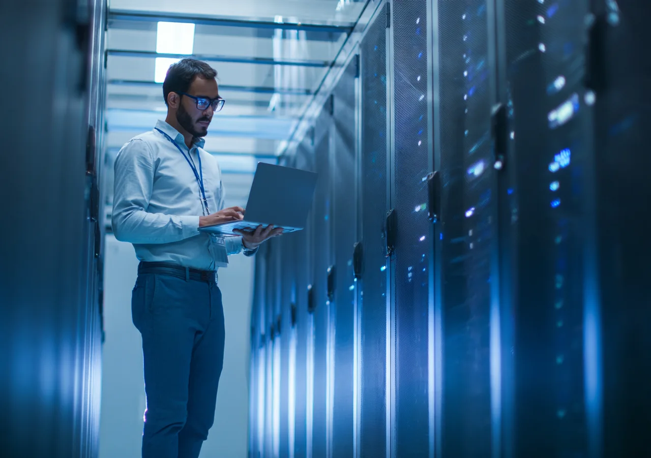 Engineer working alongside server systems